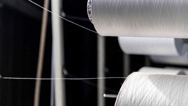 Two big white yarn rolls are in the focus