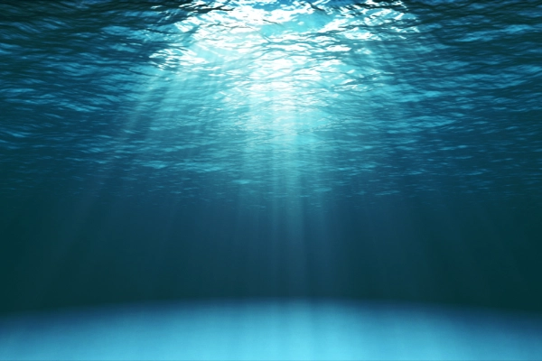 Blue ocean with lights in the water