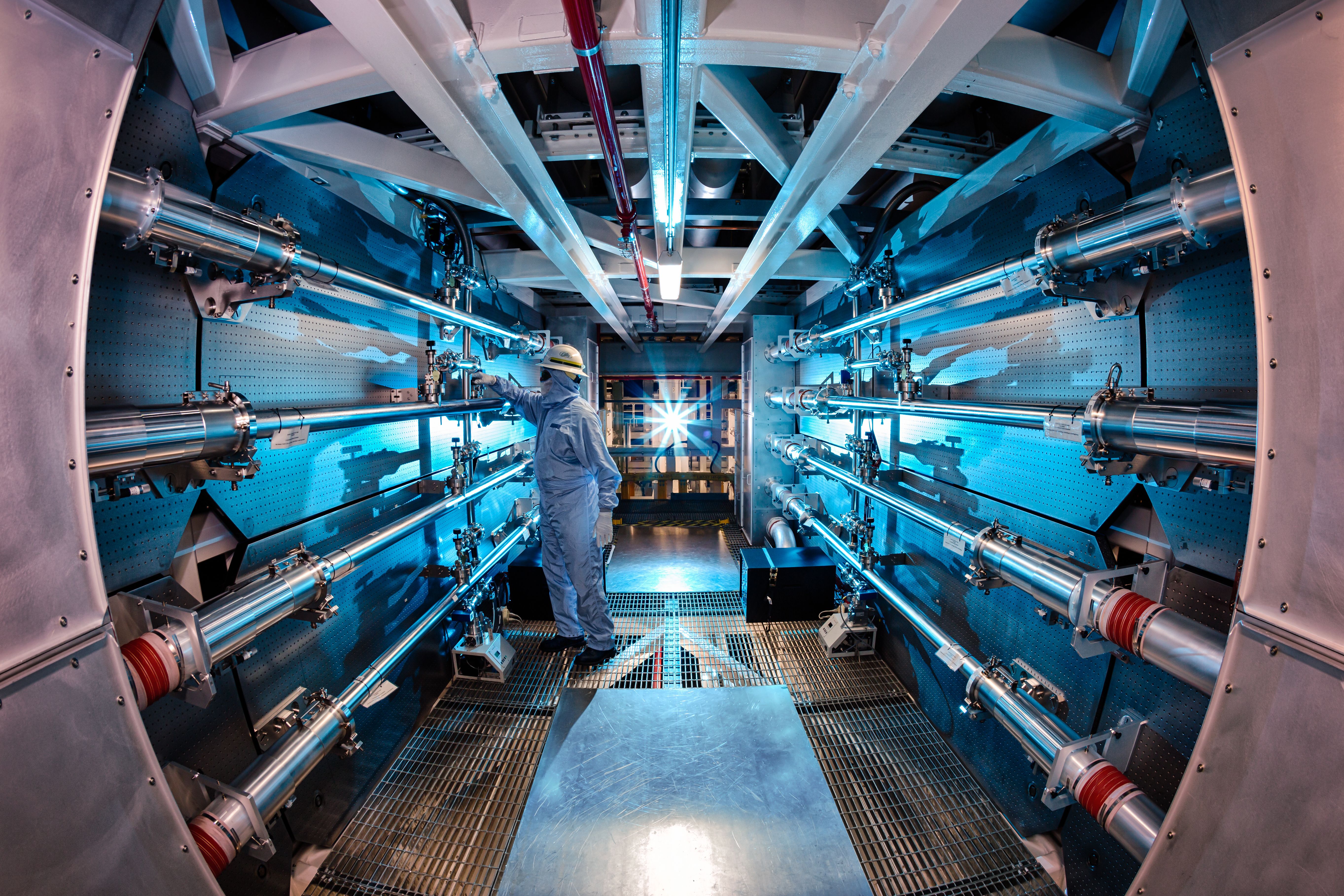 A technician adjusts an optic inside the preamplifier support structure